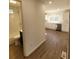 View of updated bathroom and kitchen from hallway at 1116 East Dr, Gastonia, NC 28052