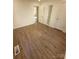 Bedroom with wood floors, built-in shelving and access to hallway at 1116 East Dr, Gastonia, NC 28052