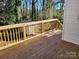 Wooden deck overlooks a fenced backyard with trees at 1116 East Dr, Gastonia, NC 28052