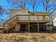 Home's back exterior showcasing a large deck and yard at 1116 East Dr, Gastonia, NC 28052