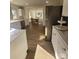 View of kitchen, dining area, and stainless steel refrigerator at 1116 East Dr, Gastonia, NC 28052