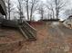 Sloped backyard with wooden stairs and retaining wall at 119 River Ridge Trl # E175/176, Mount Gilead, NC 27306