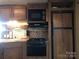 Galley kitchen with microwave, stove, and refrigerator at 119 River Ridge Trl # E175/176, Mount Gilead, NC 27306