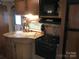 RV kitchen with sink, stove, and microwave at 119 River Ridge Trl # E175/176, Mount Gilead, NC 27306