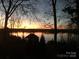 Stunning sunset over lake with house visible at 119 River Ridge Trl # E175/176, Mount Gilead, NC 27306