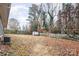 Landscaped backyard with a shed and a wooden swing set at 1335 Washington Ln, Kannapolis, NC 28083