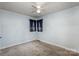 Bright bedroom featuring light blue walls, ceiling fan, and gray carpeting at 1335 Washington Ln, Kannapolis, NC 28083