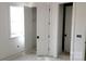 A bright room with white walls and trim with an open doorway to another room at 13618 Tranquil Day Dr, Matthews, NC 28105