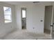 A bedroom with bright light from the window and a connected bathroom at 13618 Tranquil Day Dr, Matthews, NC 28105