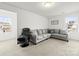 Upstairs bonus room with sectional sofa, chair, and natural light at 144 Mooring Dr, Statesville, NC 28677