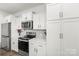Close up of kitchen featuring white cabinetry, stainless steel microwave and stove top at 144 Mooring Dr, Statesville, NC 28677