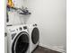 Modern laundry room with front-loading washer and dryer, and convenient overhead shelving at 144 Mooring Dr, Statesville, NC 28677