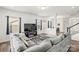 Spacious living room featuring a large sectional sofa, modern fireplace and views of the backyard at 144 Mooring Dr, Statesville, NC 28677