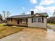 Brick ranch home with a gray accent and landscaped lawn at 1455 E Ridge Rd, Salisbury, NC 28144