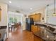 Open kitchen with granite countertops, wood cabinets, and views to the dining area at 14605 Greenpoint Ln, Huntersville, NC 28078