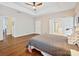 Spacious main bedroom with hardwood floors, ceiling fan, and en-suite bathroom at 14605 Greenpoint Ln, Huntersville, NC 28078