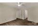 A cozy bedroom with hardwood floors, a ceiling fan, and a walk-in closet at 2227 Charlotte Hwy, York, SC 29745