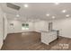 Bright, open-concept floor plan with stylish laminate flooring, recessed lighting, and a kitchen island at 2227 Charlotte Hwy, York, SC 29745