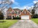 Brick two-story house with a large driveway and landscaping at 2609 Lamp Post Ln, Kannapolis, NC 28081