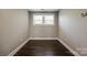 Simple bedroom with dark hardwood floors and neutral walls at 2661 Saluda Rd, Chester, SC 29706