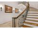 Elegant curved staircase with ornate railing and wall sconces at 3255 Lake Pointe Dr, Belmont, NC 28012