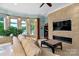 Relaxing lake view room featuring stone fireplace, comfortable seating, and large windows at 3255 Lake Pointe Dr, Belmont, NC 28012