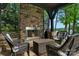 Covered patio with stone fireplace and wicker seating at 3255 Lake Pointe Dr, Belmont, NC 28012