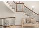 Grand staircase with ornate railing and landing bench at 3255 Lake Pointe Dr, Belmont, NC 28012