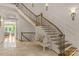 Elegant curved staircase with wrought iron railings and a light-colored wood at 3255 Lake Pointe Dr, Belmont, NC 28012