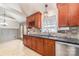 Cherry cabinets, granite counters, tile backsplash, and stainless steel dishwasher in this kitchen at 348 Sugar Creek Xing, Fort Mill, SC 29715