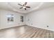 Spacious main bedroom features a tray ceiling, ceiling fan, and wood-look flooring at 348 Sugar Creek Xing, Fort Mill, SC 29715