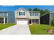 Charming two-story home featuring stone accents, a two-car garage, and a well-manicured front lawn at 3680 Charles Nw St, Conover, NC 28613