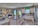Open-concept kitchen with island, white cabinets, and stainless steel appliances at 3686 Charles Nw St, Conover, NC 28613