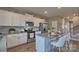 Open concept kitchen with large island, white cabinets, and stainless steel appliances at 3686 Charles Nw St, Conover, NC 28613