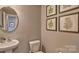 Small half bathroom with pedestal sink and framed botanical prints at 3686 Charles Nw St, Conover, NC 28613