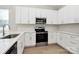 Modern kitchen with white cabinets, stainless steel appliances, and a quartz countertop at 4115 Pebblebrook Sw Cir, Concord, NC 28027