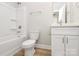 Clean bathroom, featuring a bathtub, toilet and vanity with white cabinets at 4119 Pebblebrook Sw Cir, Concord, NC 28027