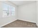 Bright bedroom with neutral walls, carpet flooring, and double door closet at 4119 Pebblebrook Sw Cir, Concord, NC 28027