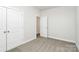 Spacious bedroom with neutral walls, carpet flooring and double door closet at 4119 Pebblebrook Sw Cir, Concord, NC 28027