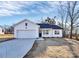 White house with black roof, attached garage, and small front yard at 4119 Pebblebrook Sw Cir, Concord, NC 28027