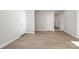 Bright hallway with LVP flooring and multiple doors to bedrooms and bathroom at 4119 Pebblebrook Sw Cir, Concord, NC 28027