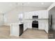 Modern kitchen with white cabinets and stainless steel appliances at 4119 Pebblebrook Sw Cir, Concord, NC 28027