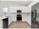 Modern kitchen with white cabinets, stainless steel appliances, and quartz counters at 4119 Pebblebrook Sw Cir, Concord, NC 28027