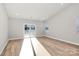 Sunlit living room with LVP flooring and sliding glass doors at 4119 Pebblebrook Sw Cir, Concord, NC 28027