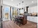 Modern kitchen boasts an island with seating, stainless steel appliances, and outdoor access at 5715 Castlerea Dr, Charlotte, NC 28217