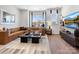 Inviting living room features a sectional sofa, large windows, and a contemporary entertainment center at 5715 Castlerea Dr, Charlotte, NC 28217