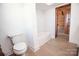 Bathroom with a tub and a toilet, near a log cabin bedroom at 604 N Central Ave, Locust, NC 28097