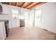 Bright kitchen with white cabinets, stainless steel appliances, and wood floors at 604 N Central Ave, Locust, NC 28097