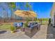 Relaxing backyard with outdoor seating, patio, and large shade umbrella is perfect for entertaining at 7150 Irongate Dr, Indian Land, SC 29707