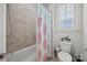 Bright bathroom boasts a combination tub and shower with stylish tile surround at 7150 Irongate Dr, Indian Land, SC 29707
